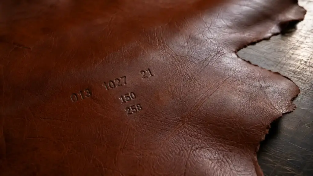 First shipment of fully traceable leather, featuring numerical markings engraved on the leather surface (shown in close-up), reinforcing traceability and origin control; socio-environmental monitoring.