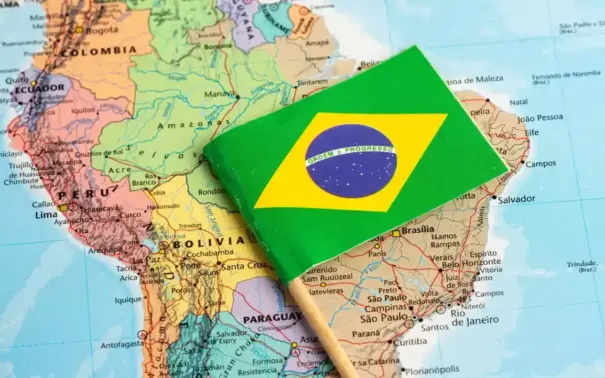 Brazilian flag over a map of South America, showing states and countries in the background; reference for the CBAM and Brazilian beef theme.