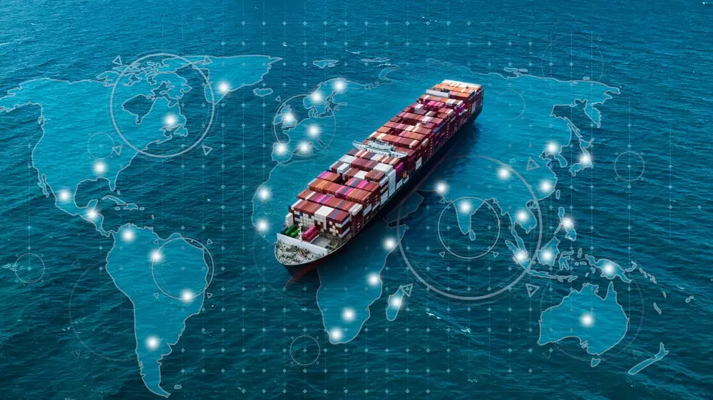 Container ship sailing the ocean with a digital world map in the background